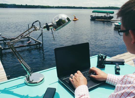 Working on laptop at the lake